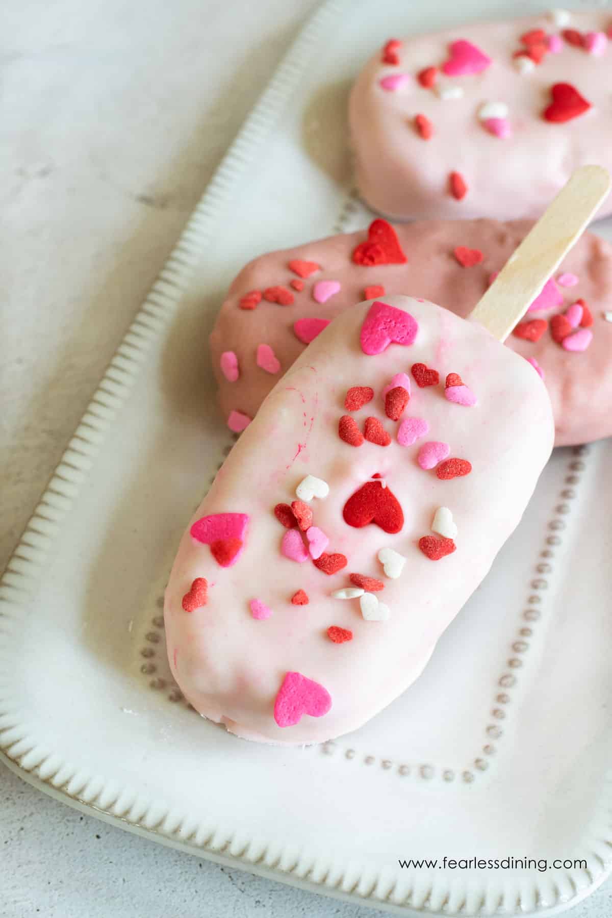 Valentine's day cakesicles on a plate.