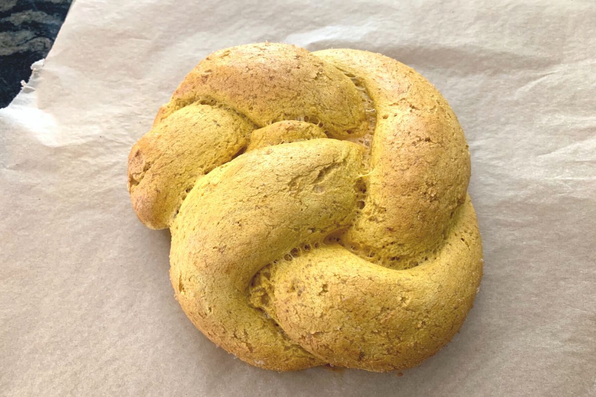 a baked round pumpkin challah.