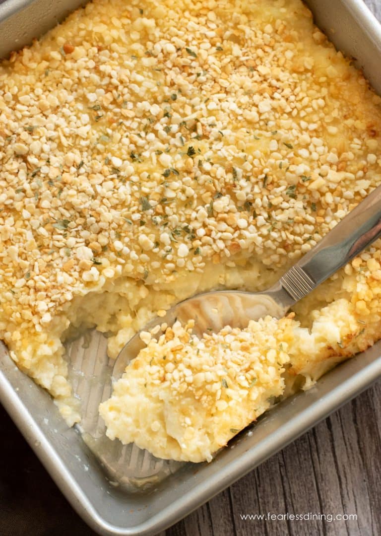 An 8x8 baking dish filled with mashed cauliflower.