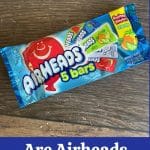 A Pinterest image of a package of Airheads on a wooden table.