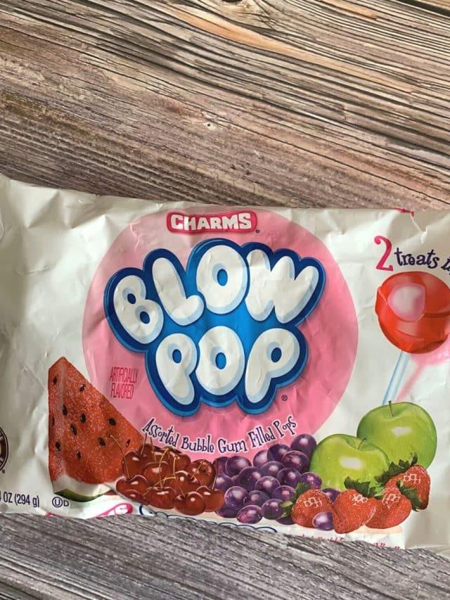 a bag of blow pops on a wooden table.