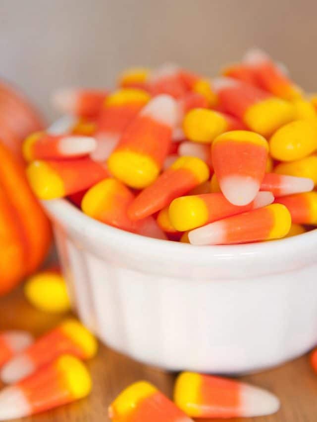 A small white ramekin filled with candy corn.