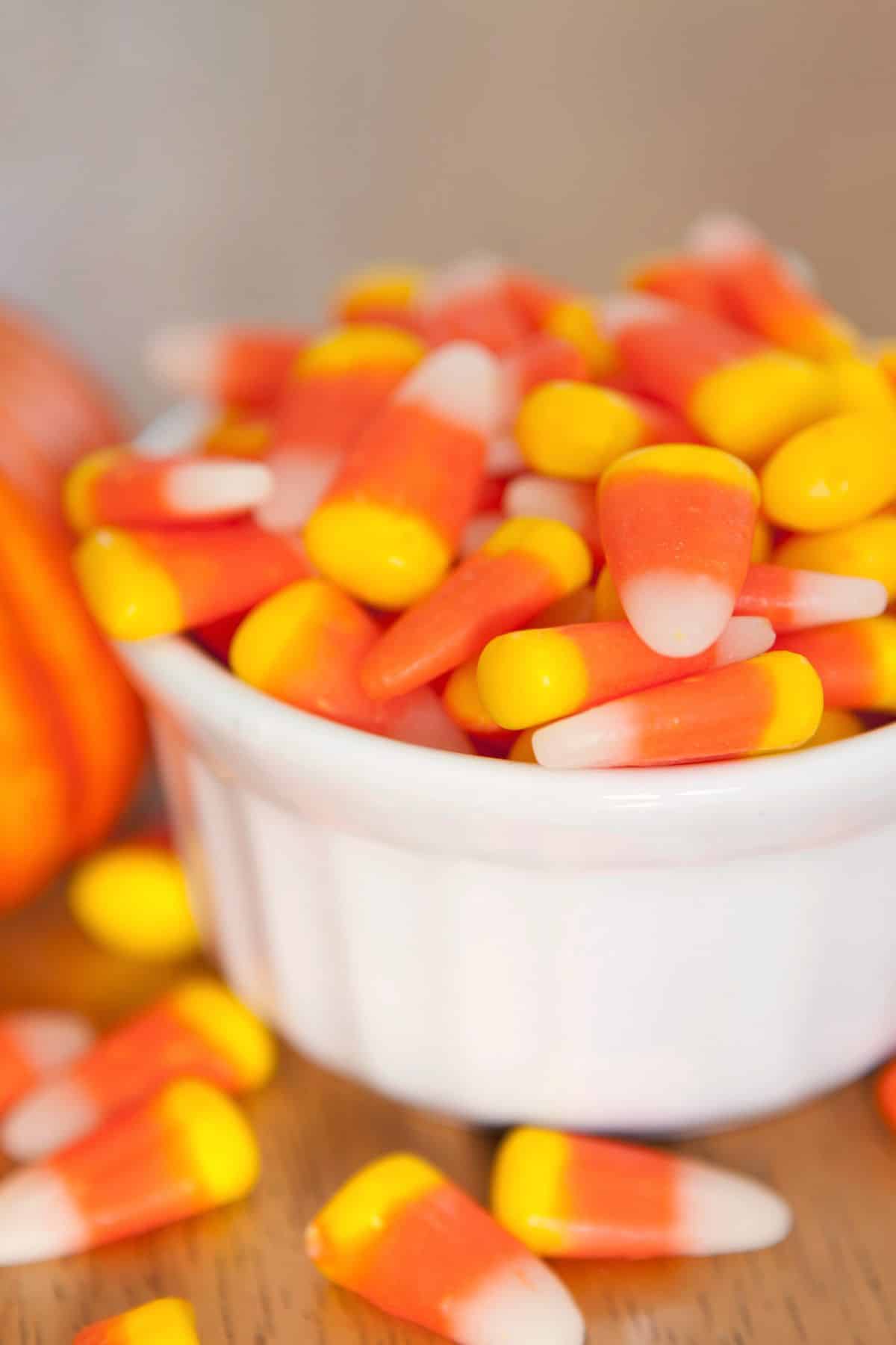a small white ramekin filled with candy corn.