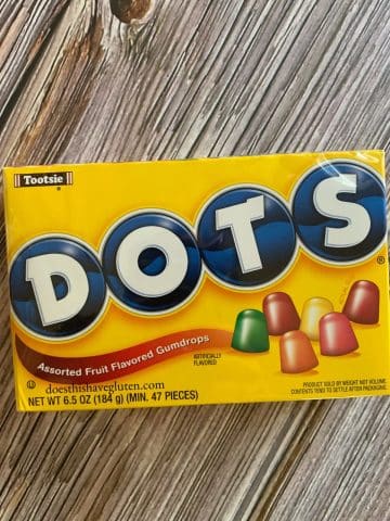 a box of dots candy on a wooden table.