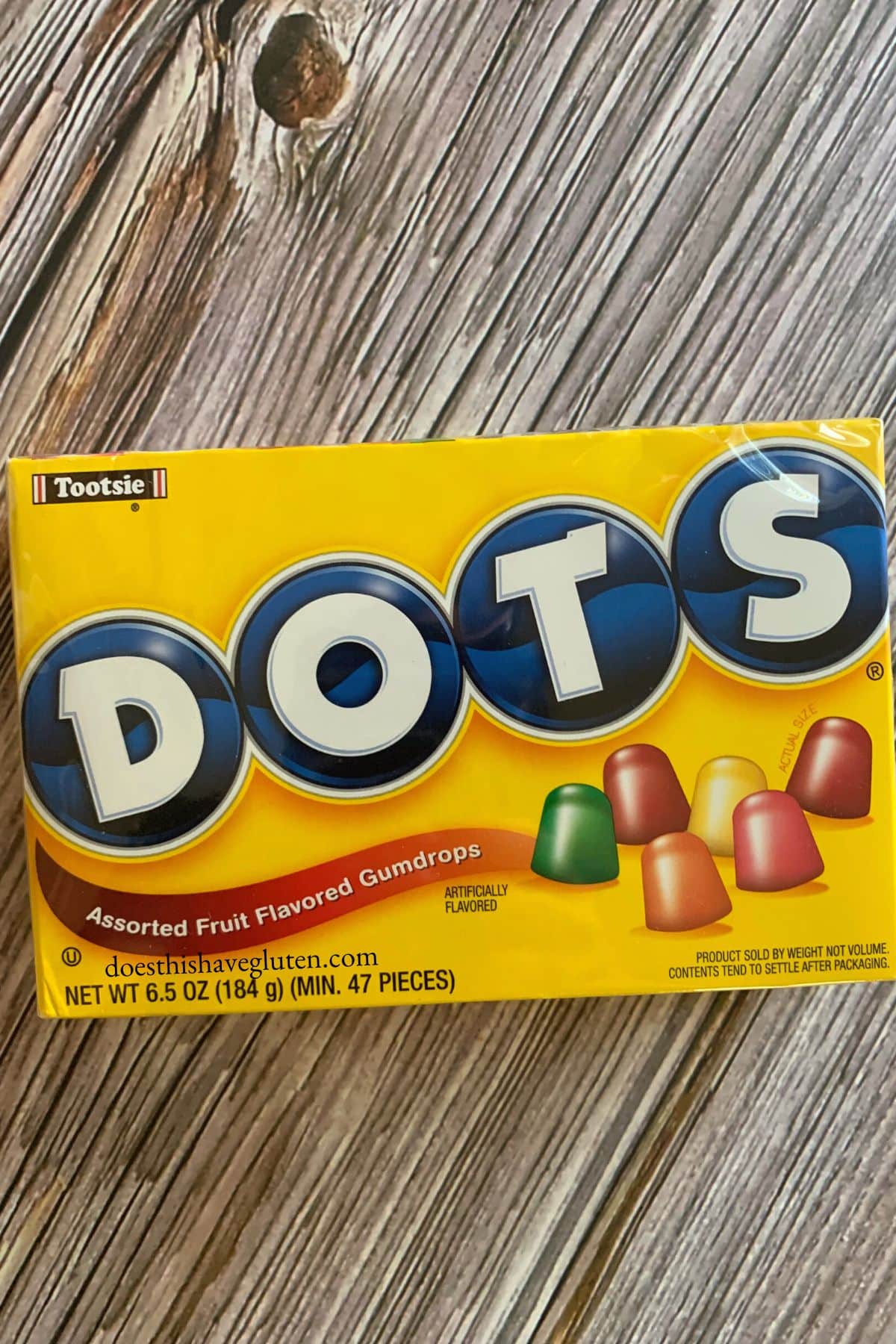 A box of dots candy on a wooden table.