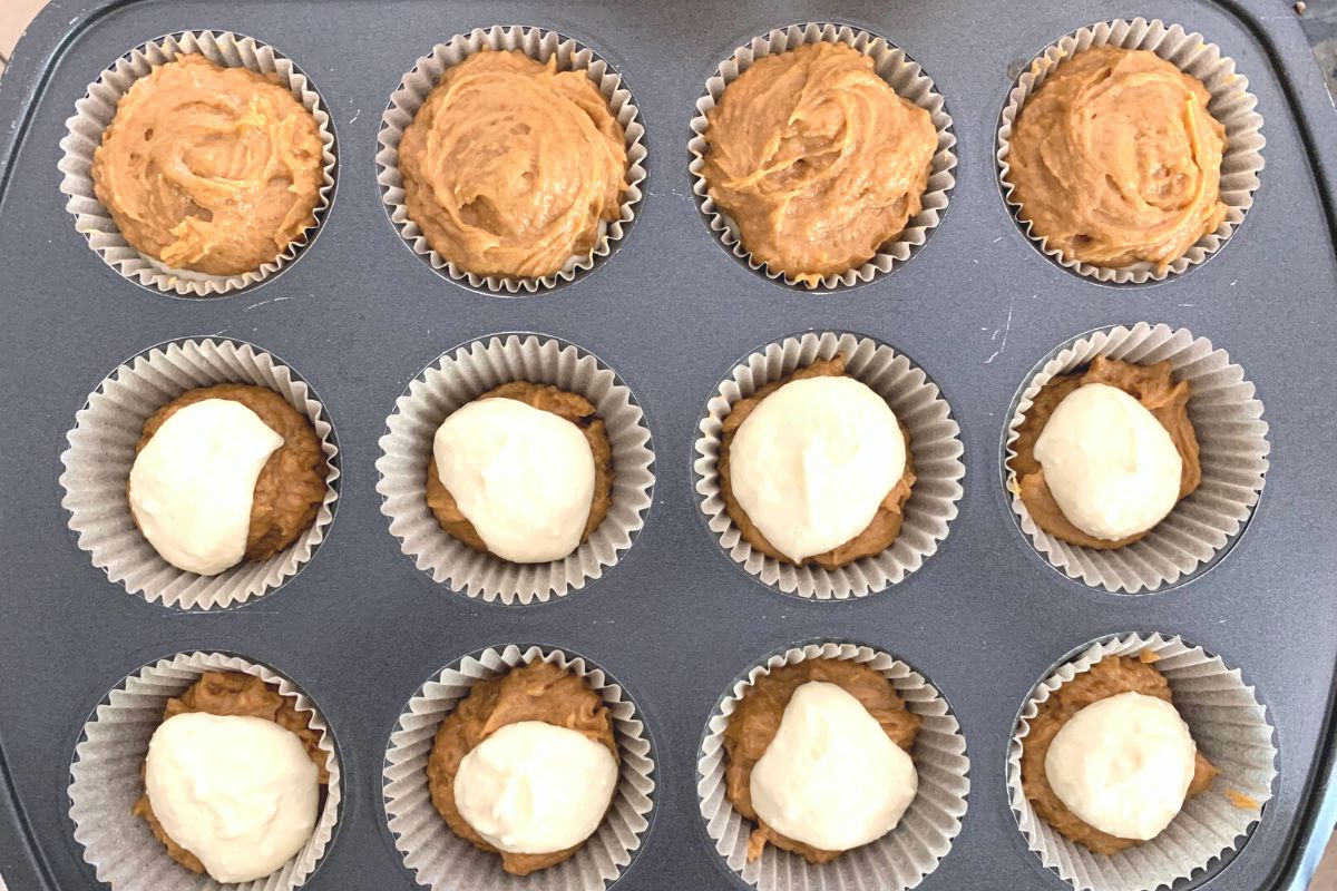 A photo of the pumpkin and cream cheese in the muffin pan.