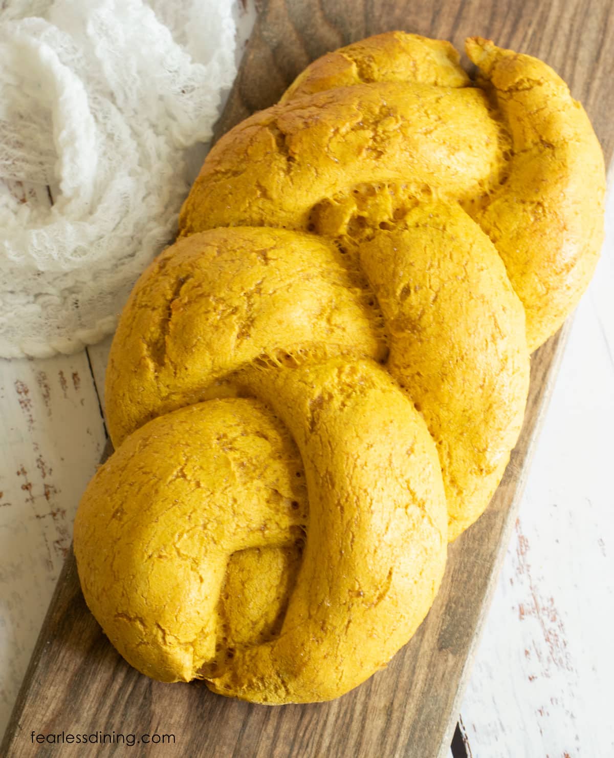 The top view of a baked braided pumpkin challah.