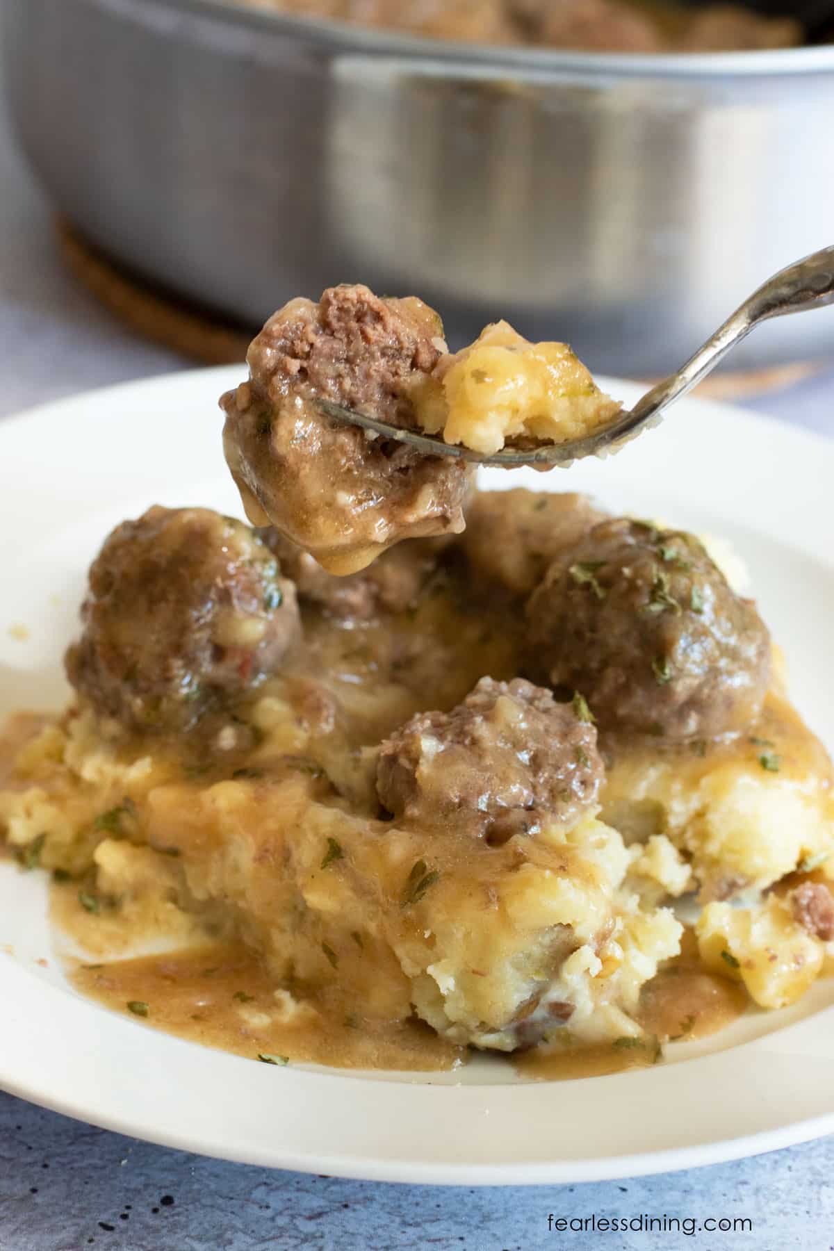 A fork holding up a Swedish meatball.
