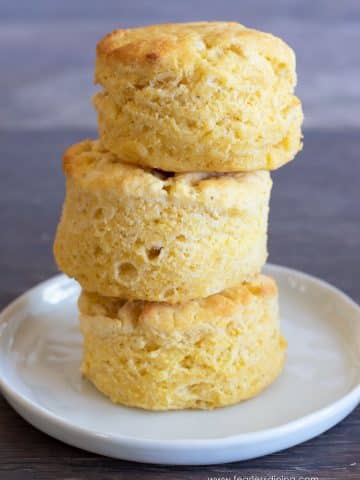 Three gluten free cornmeal biscuits stacked on top of each other.