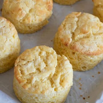 Baked cornmeal biscuits on a baking sheet.