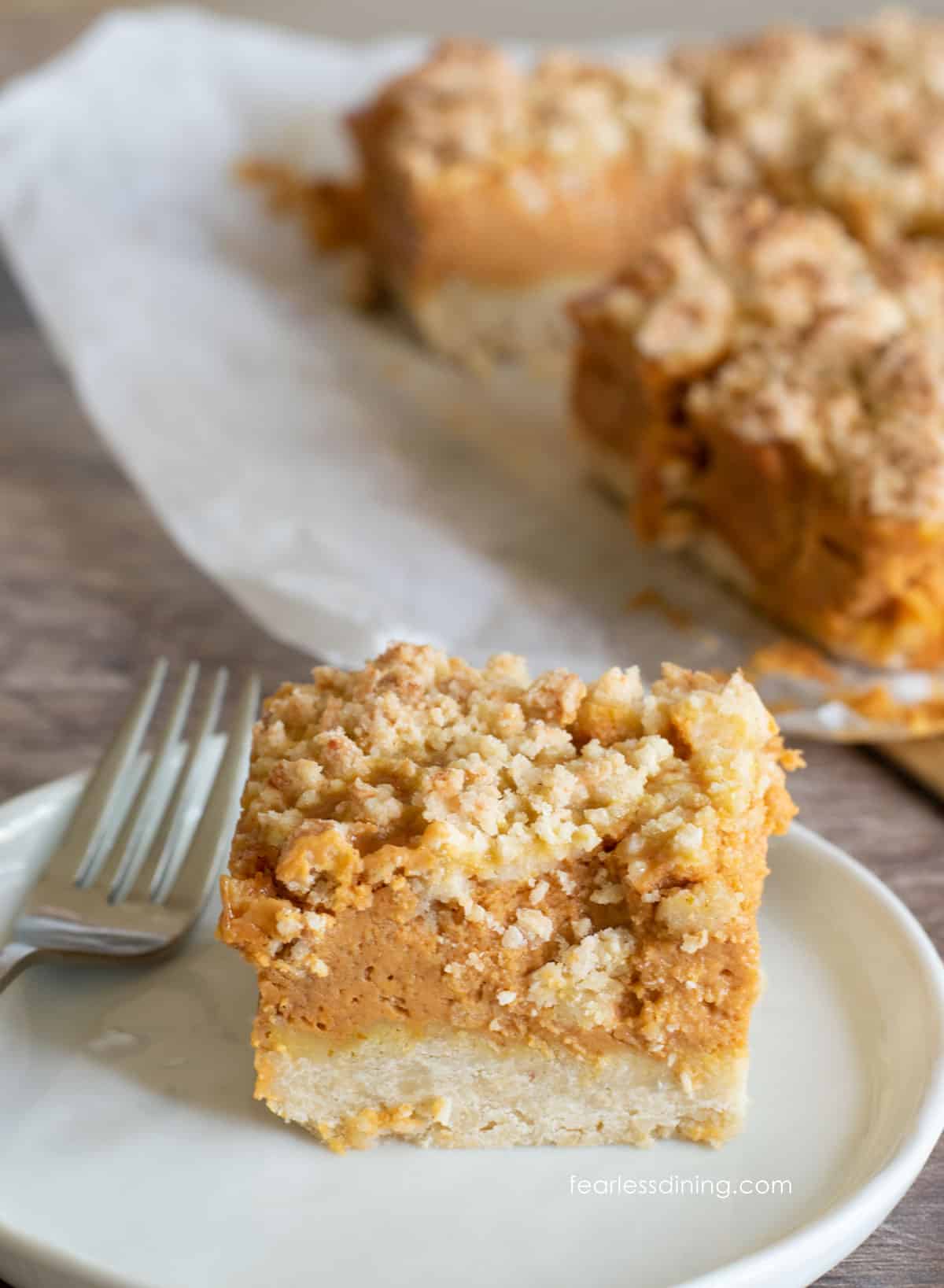 A pumpkin pie bar on a small white plate.