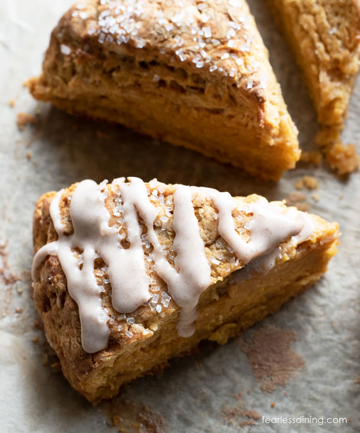 The top of an iced gluten free pumpkin scone.