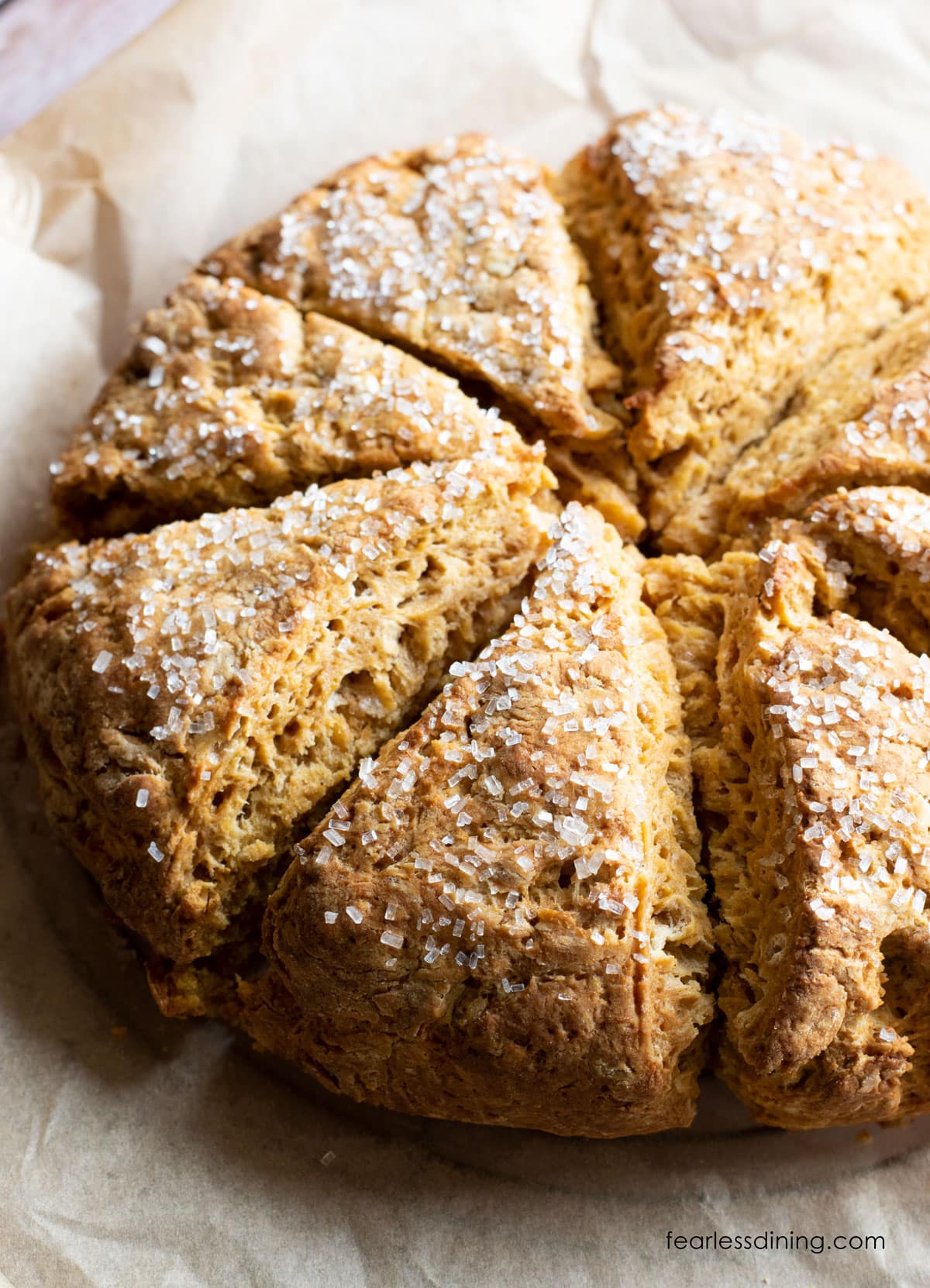 Baked pumpkin scones on a baking sheet.