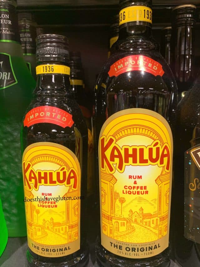 bottles of kahlua on a shelf.