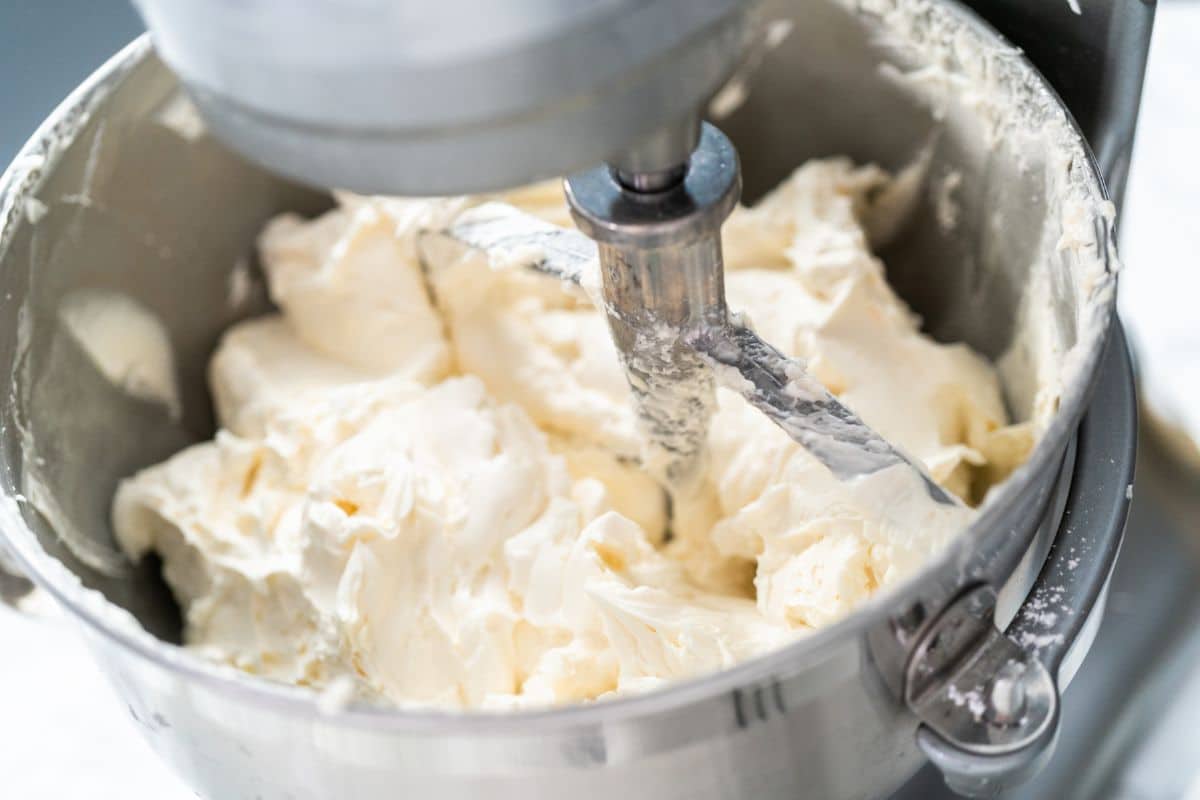 A mixing bowl full of vanilla frosting.