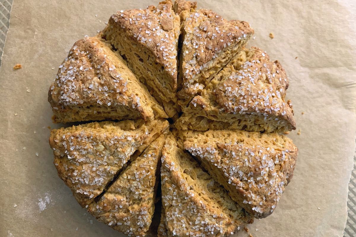 Baked scones on a cookie sheet.