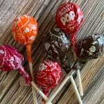 a pinterest image of tootsie pops on a table.