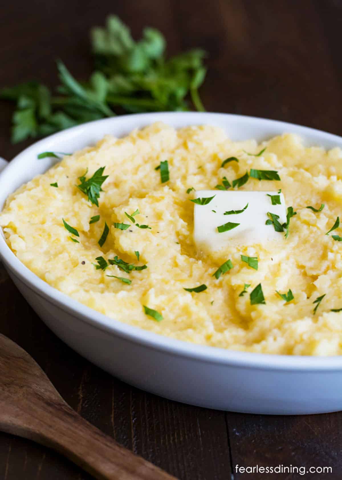 A white casserole dish filled with mashed rutabagas.