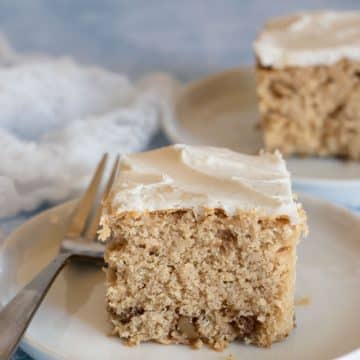 Two slices of apple cider cake with vanilla frosting.