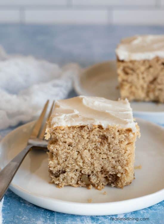Two slices of apple cider cake with vanilla frosting.