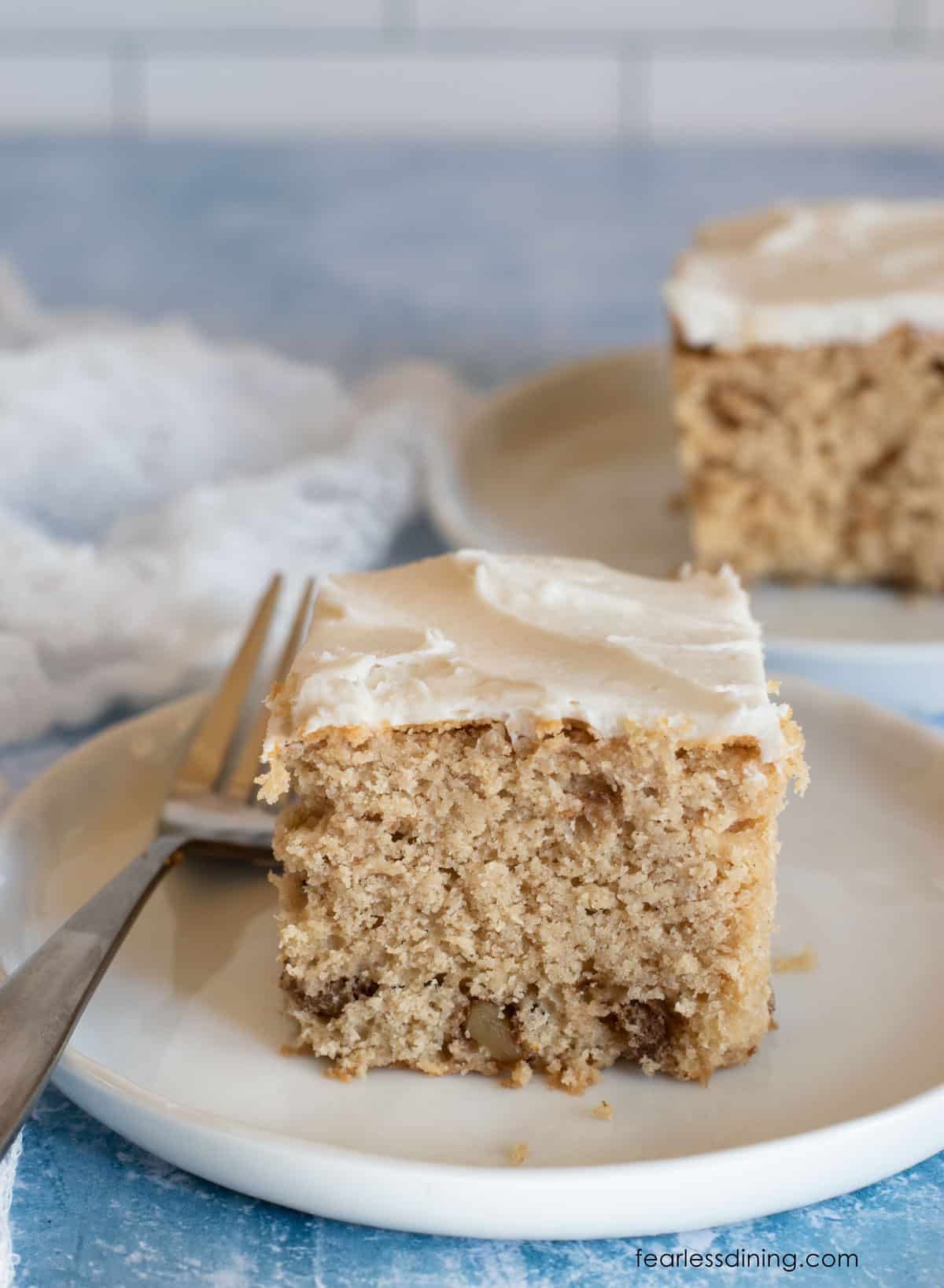 Two slices of apple cider cake with vanilla frosting.