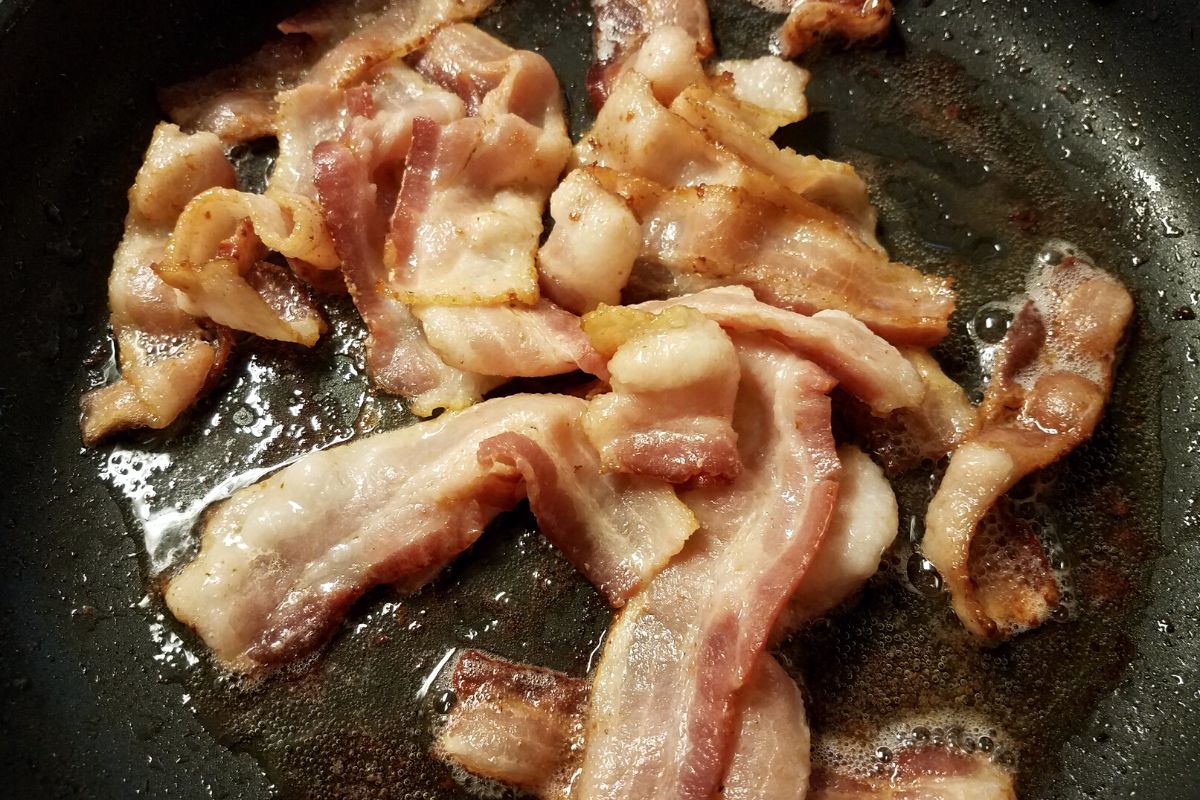 Cooking bacon in a skillet.