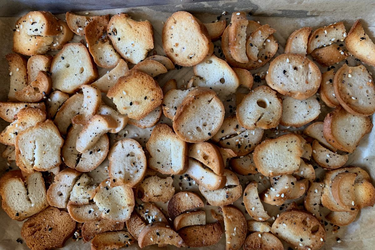 The baked bagel chips on the baking sheet.