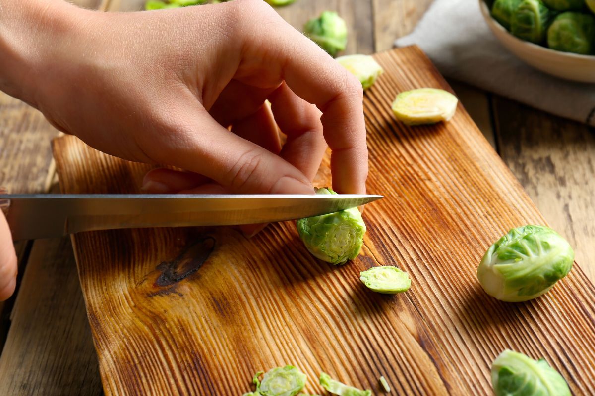 Slicing the ends off brussels sprouts.