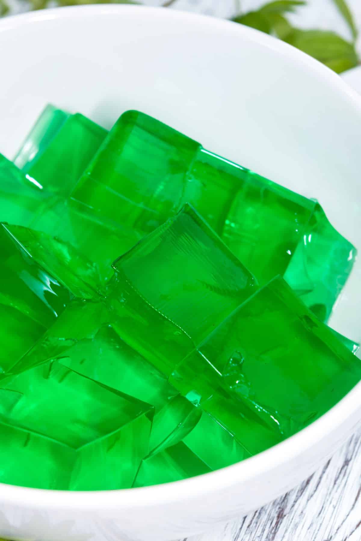 A whitebowl of green jello.