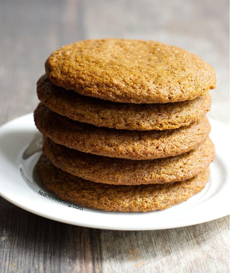 A stack of five gluten free molasses cookies on a plate.