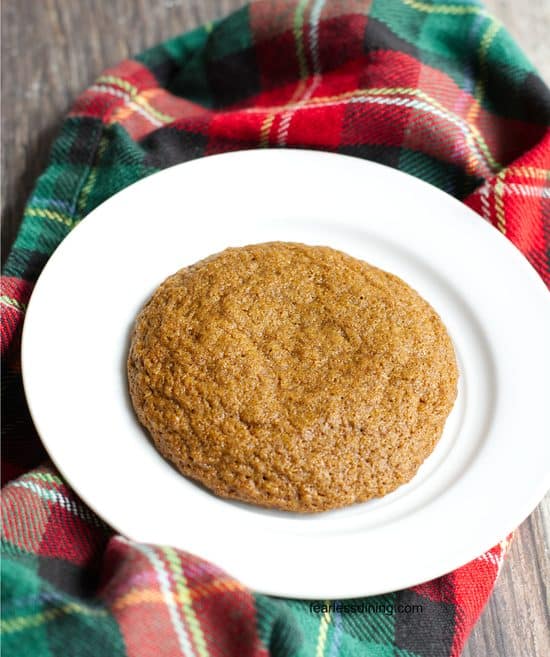 A single molasses cookie on a plate.