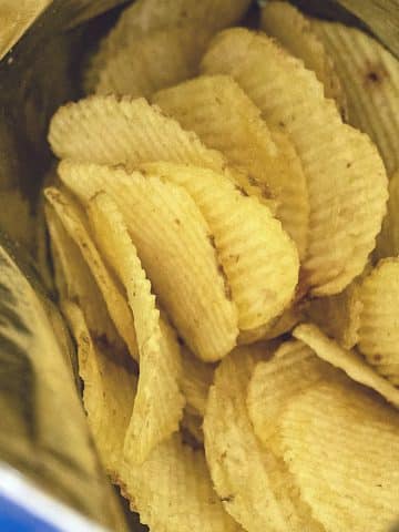 A photo showing the top of an open bag of ruffles.
