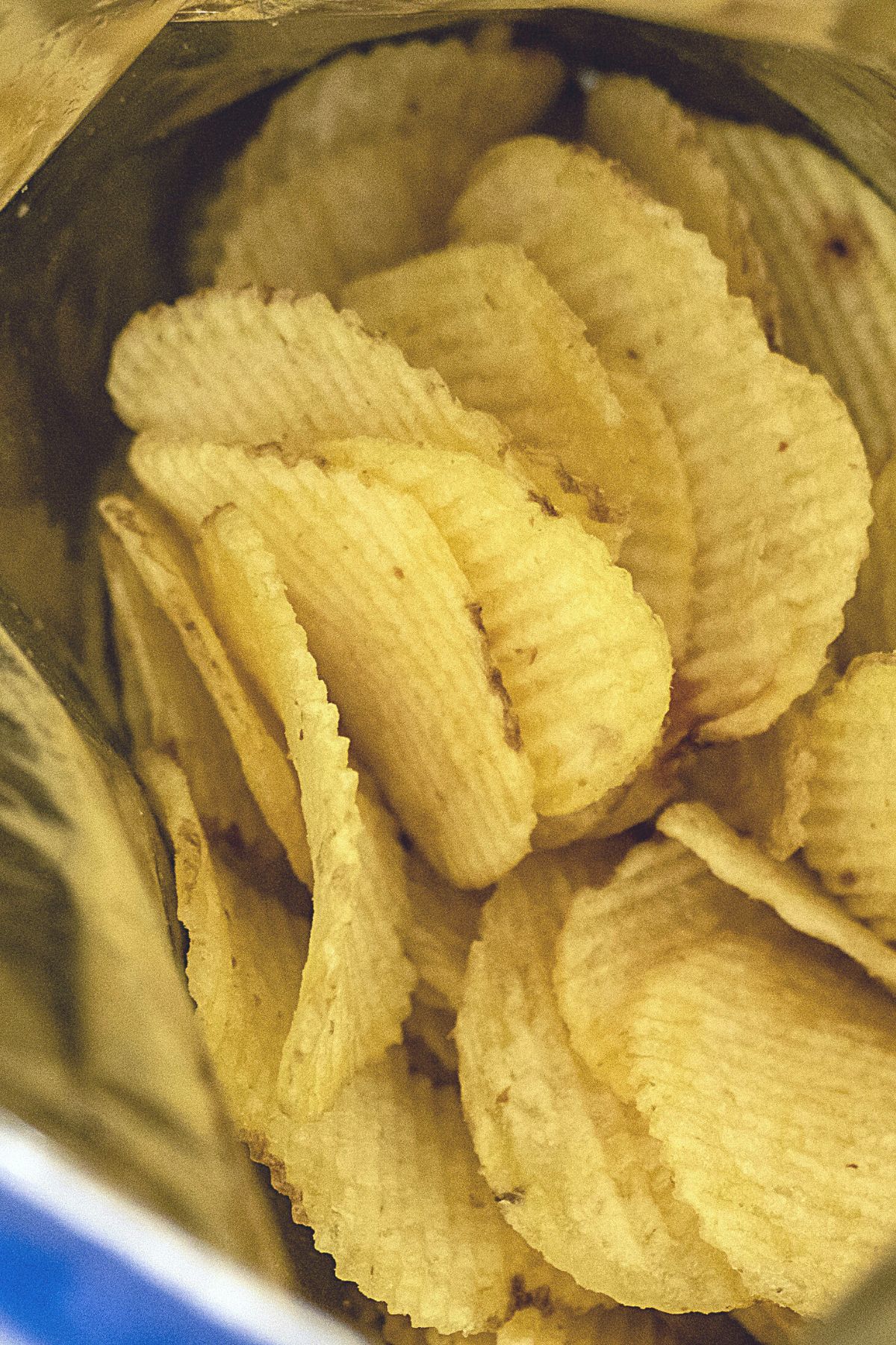 A photo showing the top of an open bag of ruffles.