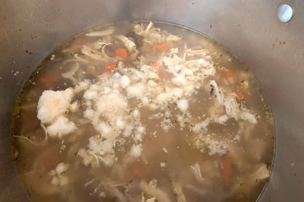 Adding the parmesan to the soup.