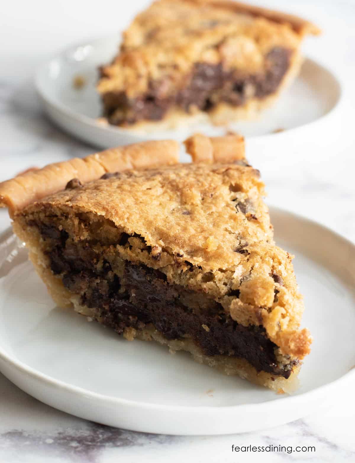 Slices of gluten free derby pie on two white plates.