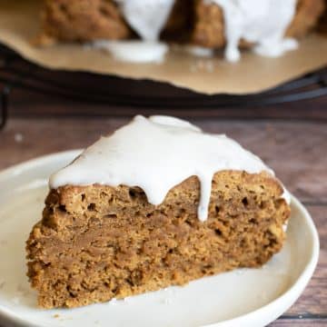 an iced gingerbread scone on a plate.