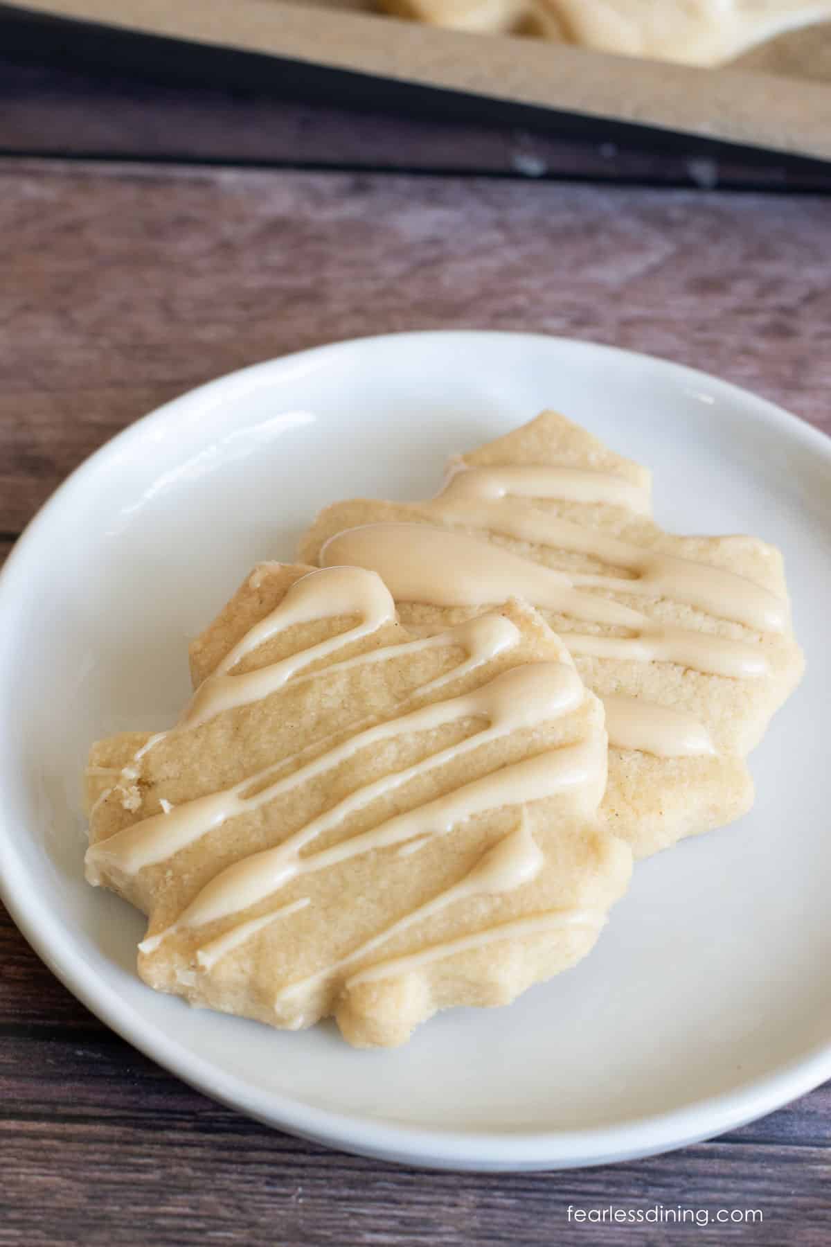 To maple shortbread cookies on a plate.