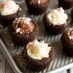 Several gluten free peppermint cookie cups on a baking sheet.