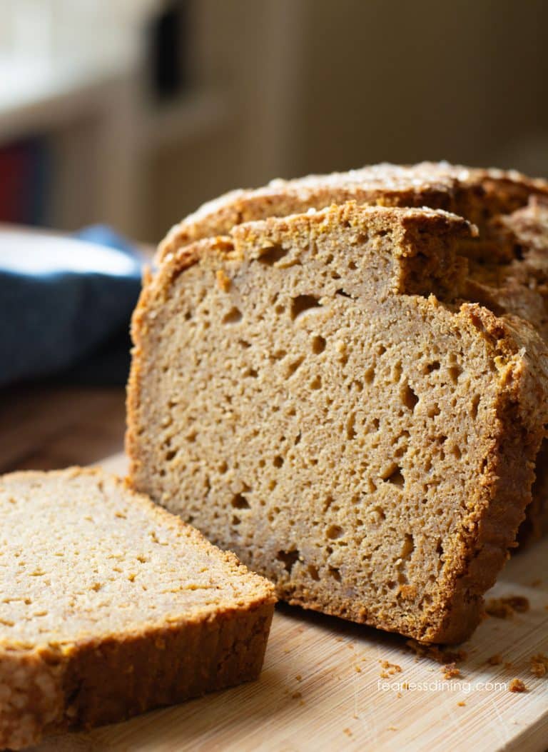 A sliced gluten free sweet potato cake on a cutting board.