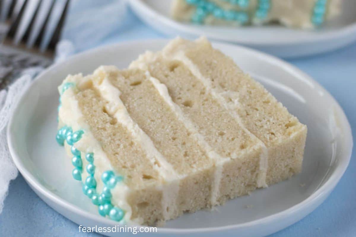 A slice of gluten-free vanilla cake on a plate.