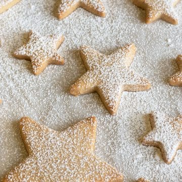 Cinnamon sugar cookie stars dusted with powdered sugar.