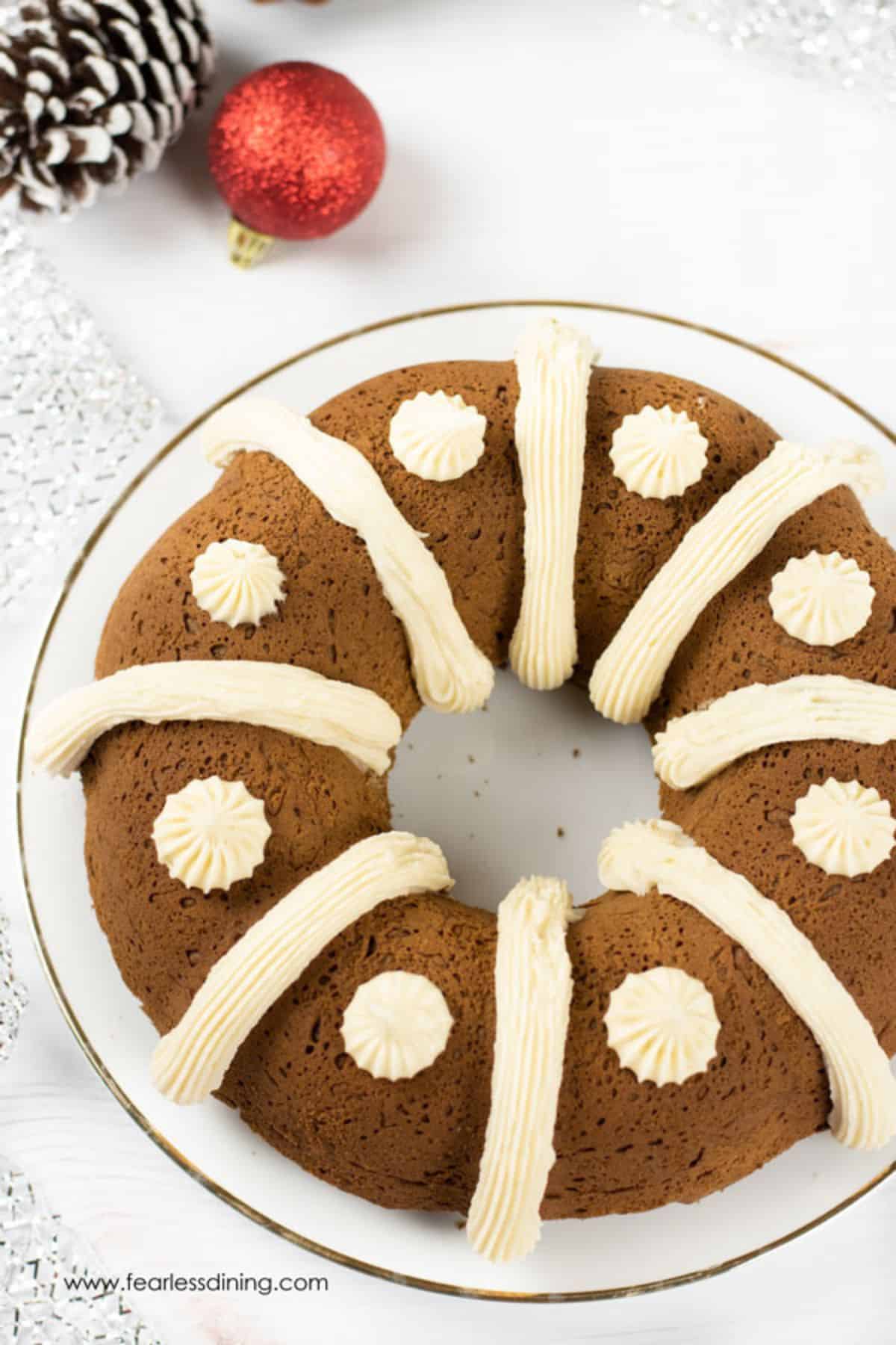 A gluten free gingerbread bundt cake decorated with frosting.