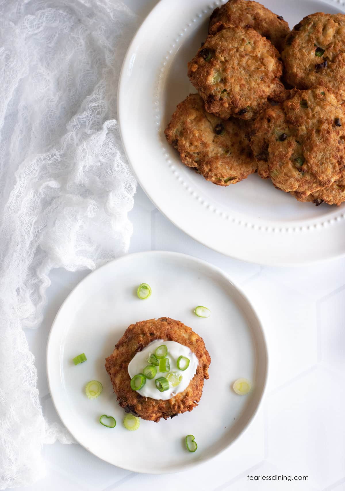 The top view of the salmon cakes on two plates.
