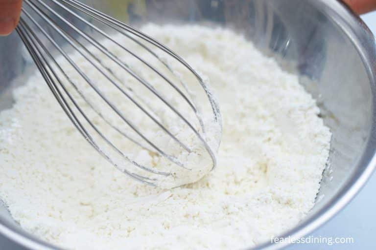 Whisking flour in a bowl.