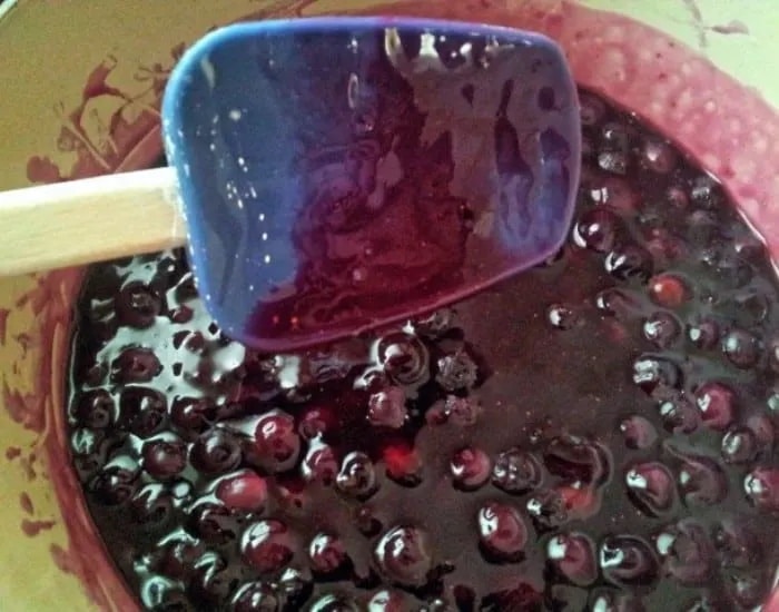 Stirring blueberry syrup.