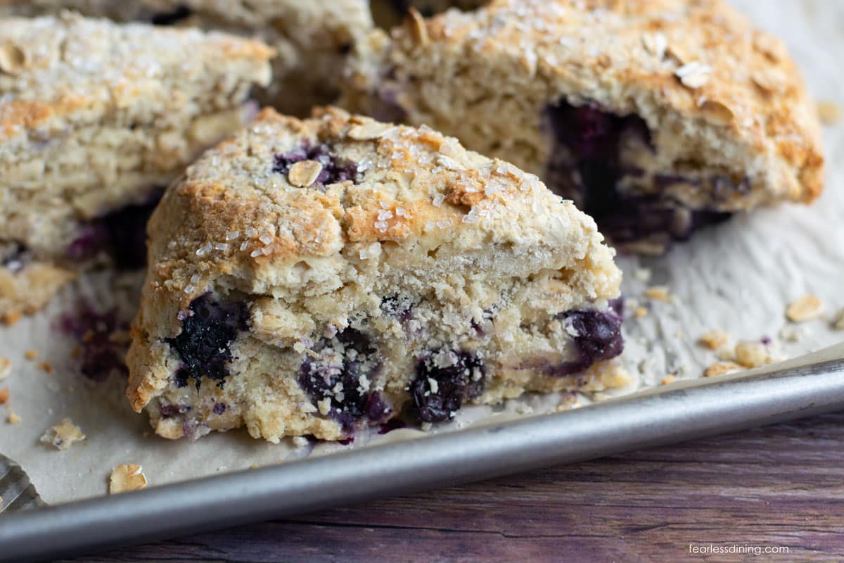 A close up of a gluten free oat scone with blueberries.