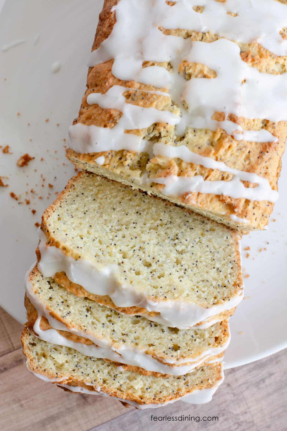 A top view of the sliced gluten free lemon poppy seed cake.