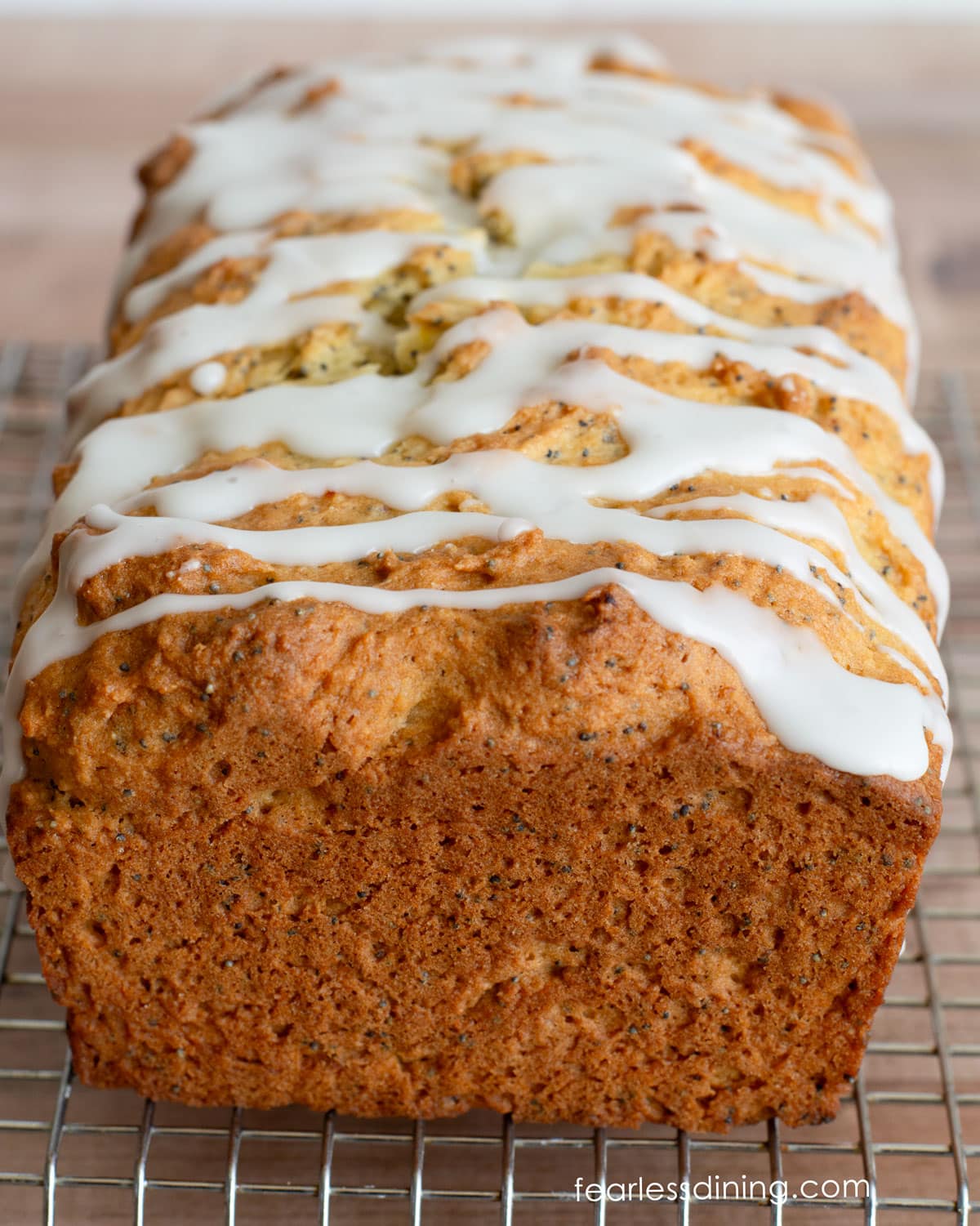 The front view of the whole lemon poppy seed cake with lemonade icing.