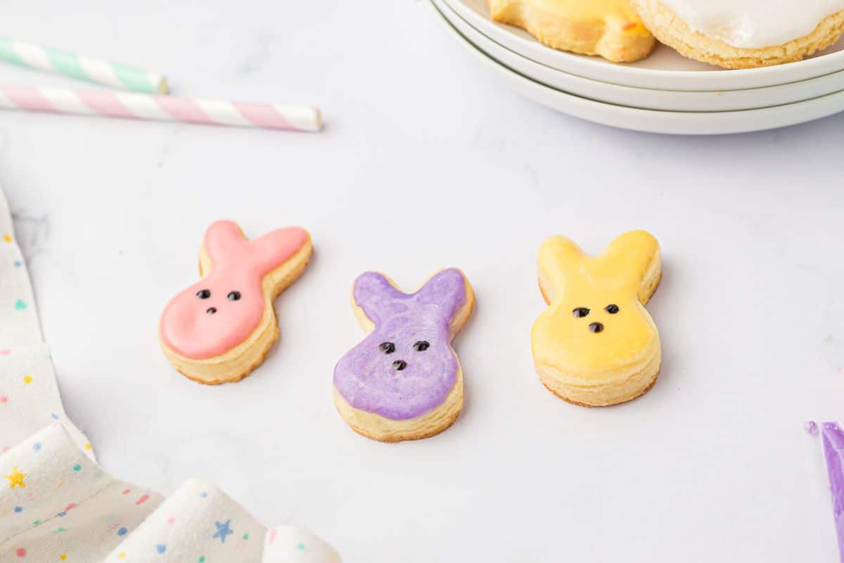 Three colors of iced bunny cookies.