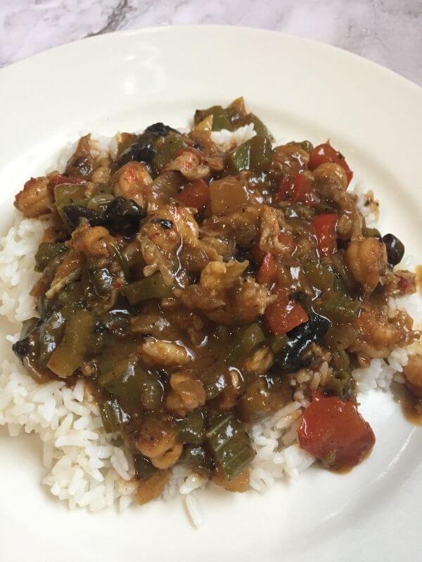 Crawfish etouffee over a bed of white rice.